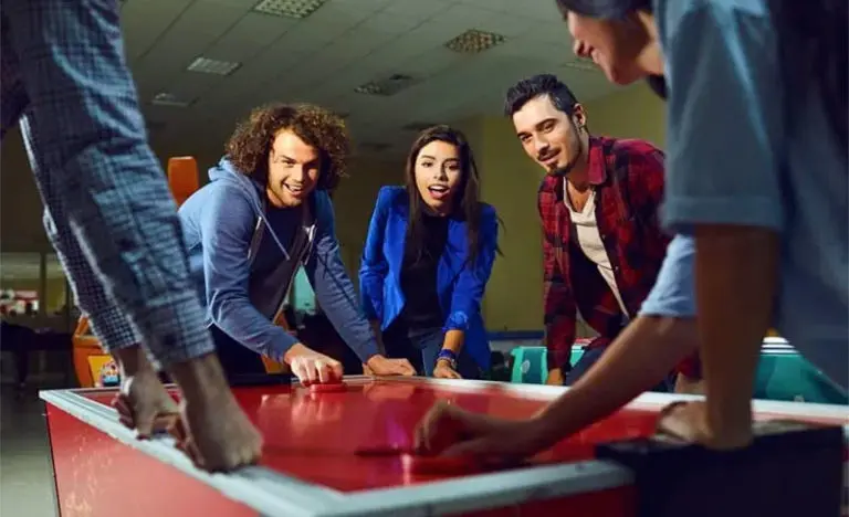 friends playing air hockey